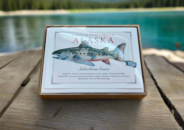 Box with Alaska-themed design featuring a fish illustration on a wooden surface